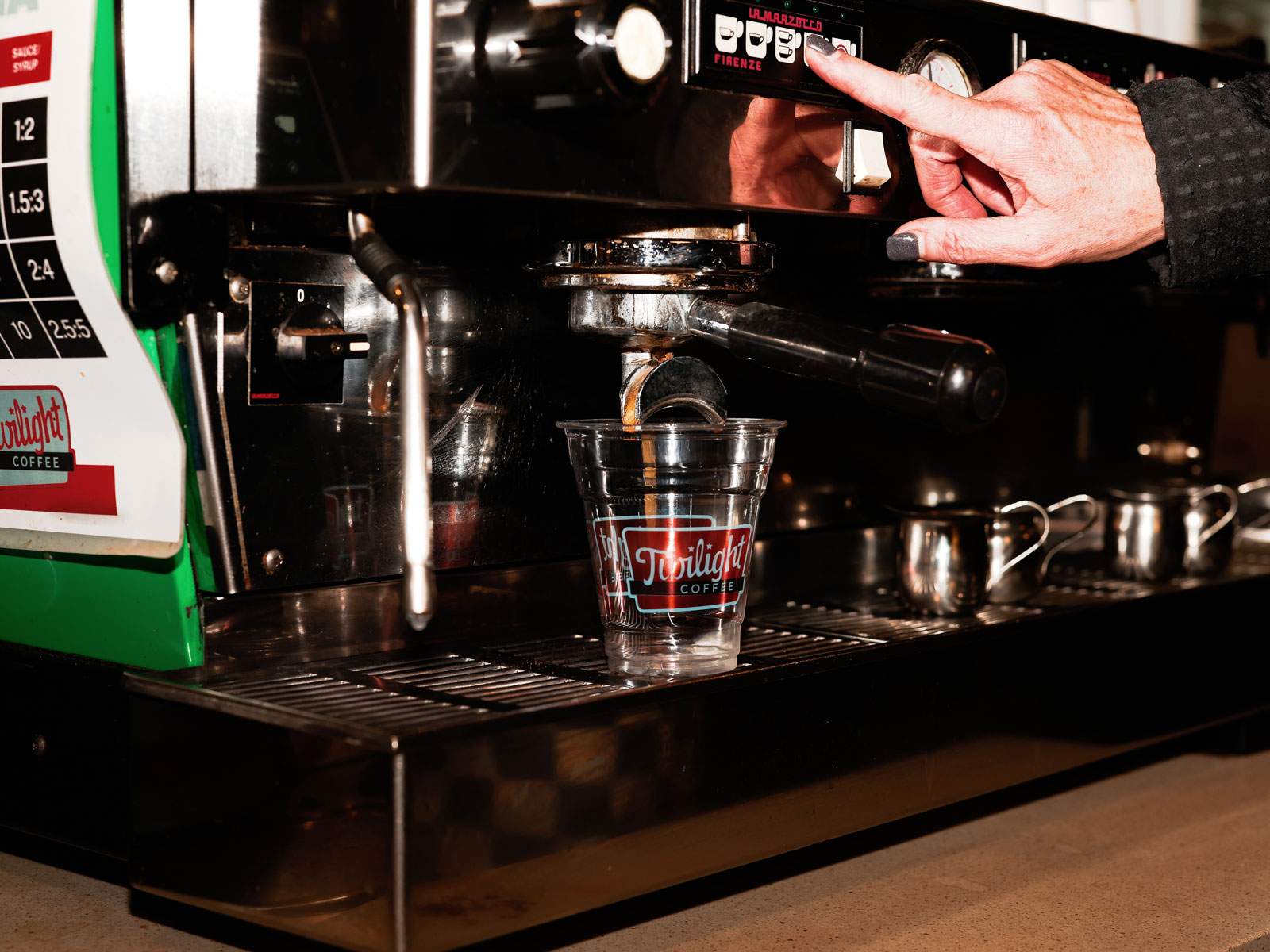 Barista pulling espresso into a branded cup — Dallas brand and commercial photography by BK Bennett