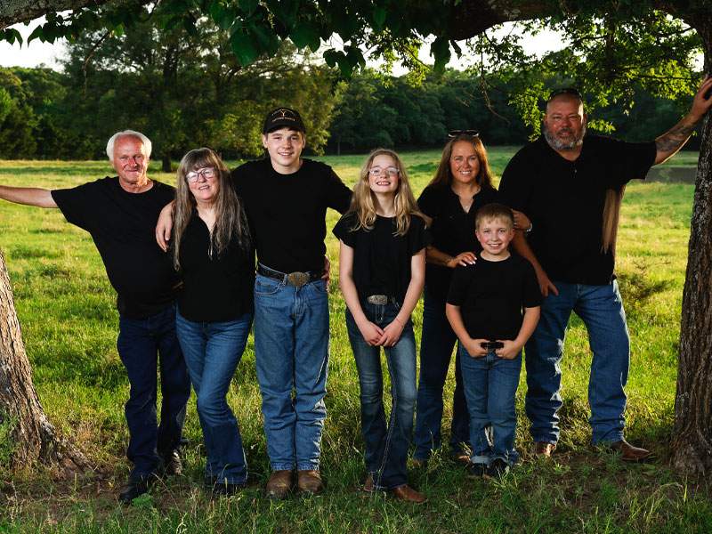 Family under a large oak tree at golden hour — McKinney family photographer BK Bennett