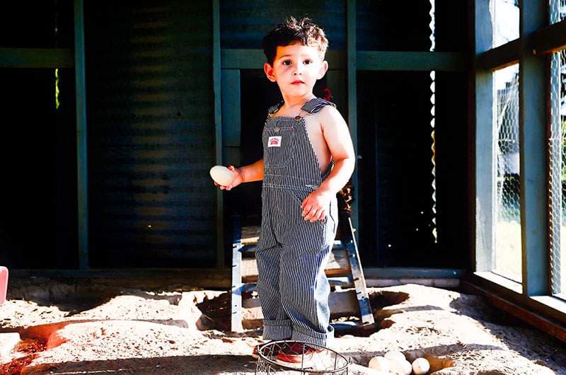 Toddler in striped overalls in warm light — Fort Worth newborn and little-ones photography by BK Bennett