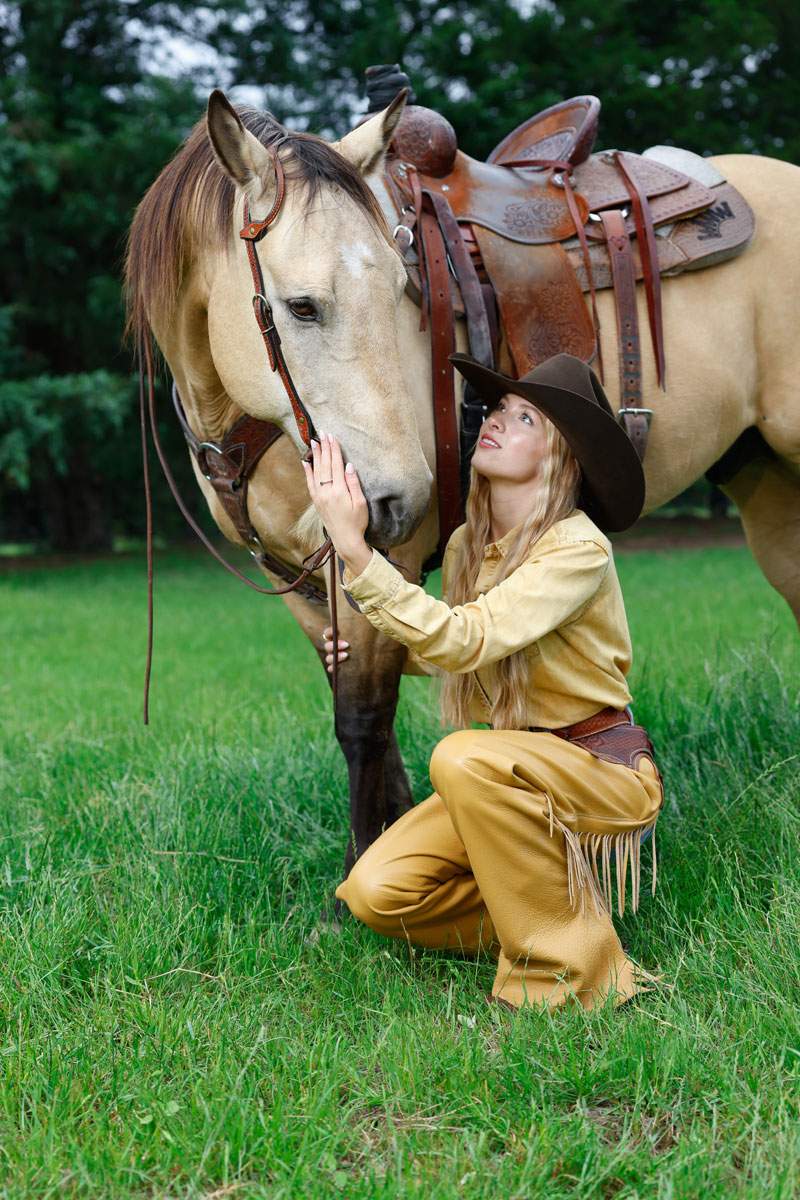 Woman in a cowboy hat with a buckskin horse in a pasture — Arlington portrait session by BK Bennett
