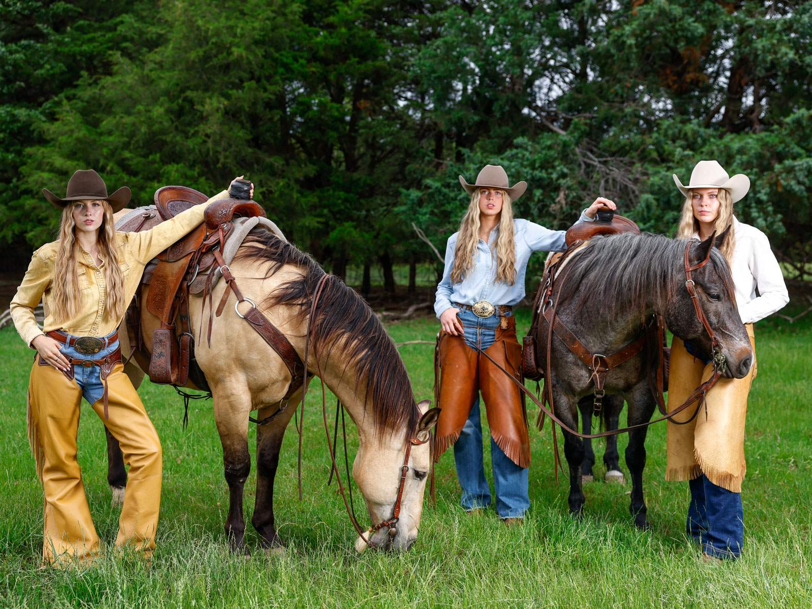 Two women in Western attire with horses in a pasture — Rockwall portrait session by BK Bennett